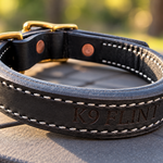 Back of black leather working collar showing K9 FLINT engraving and white stitching
