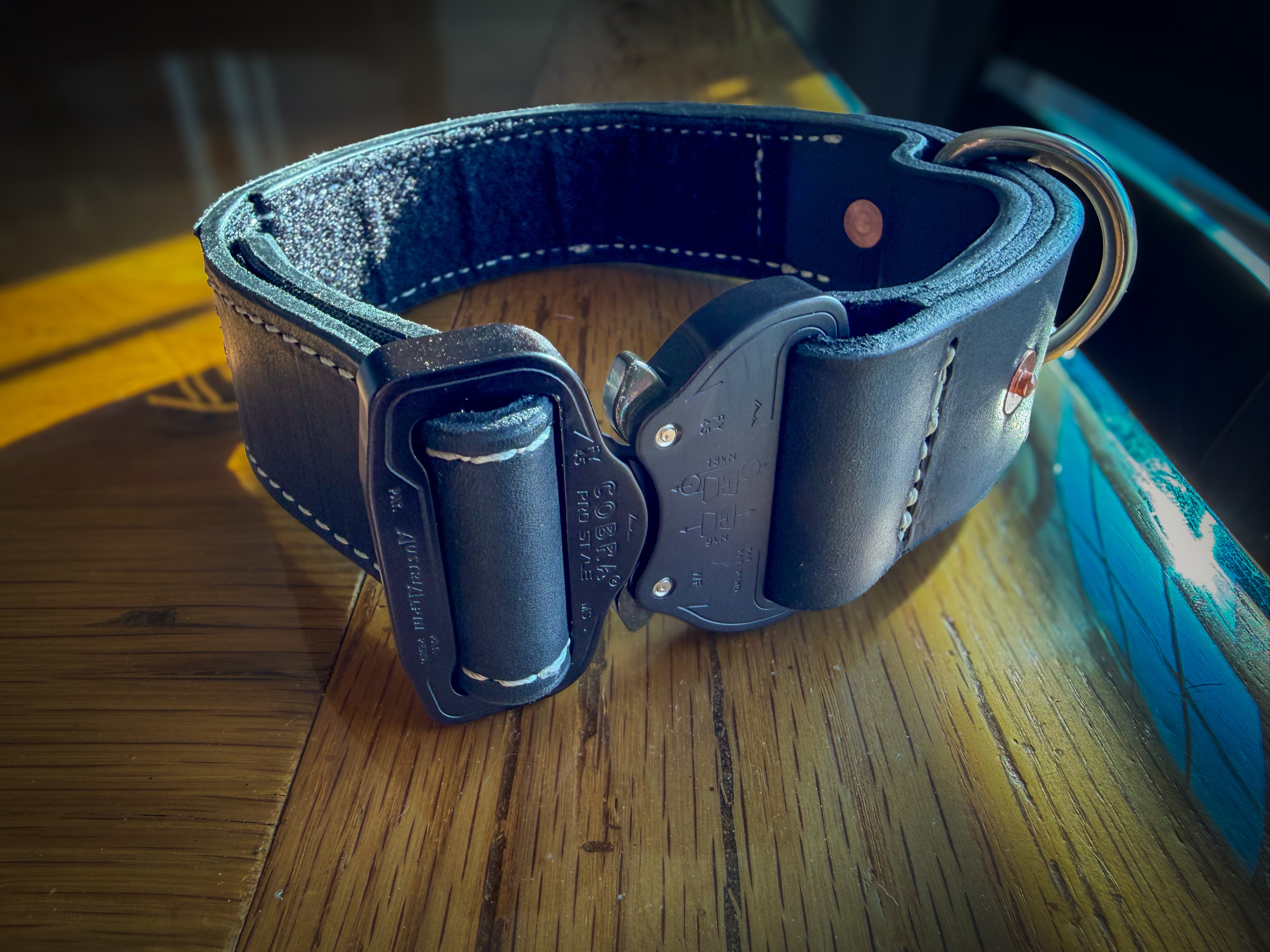 Black leather COBRA working collar showing quick-release buckle, stitching and D-ring
