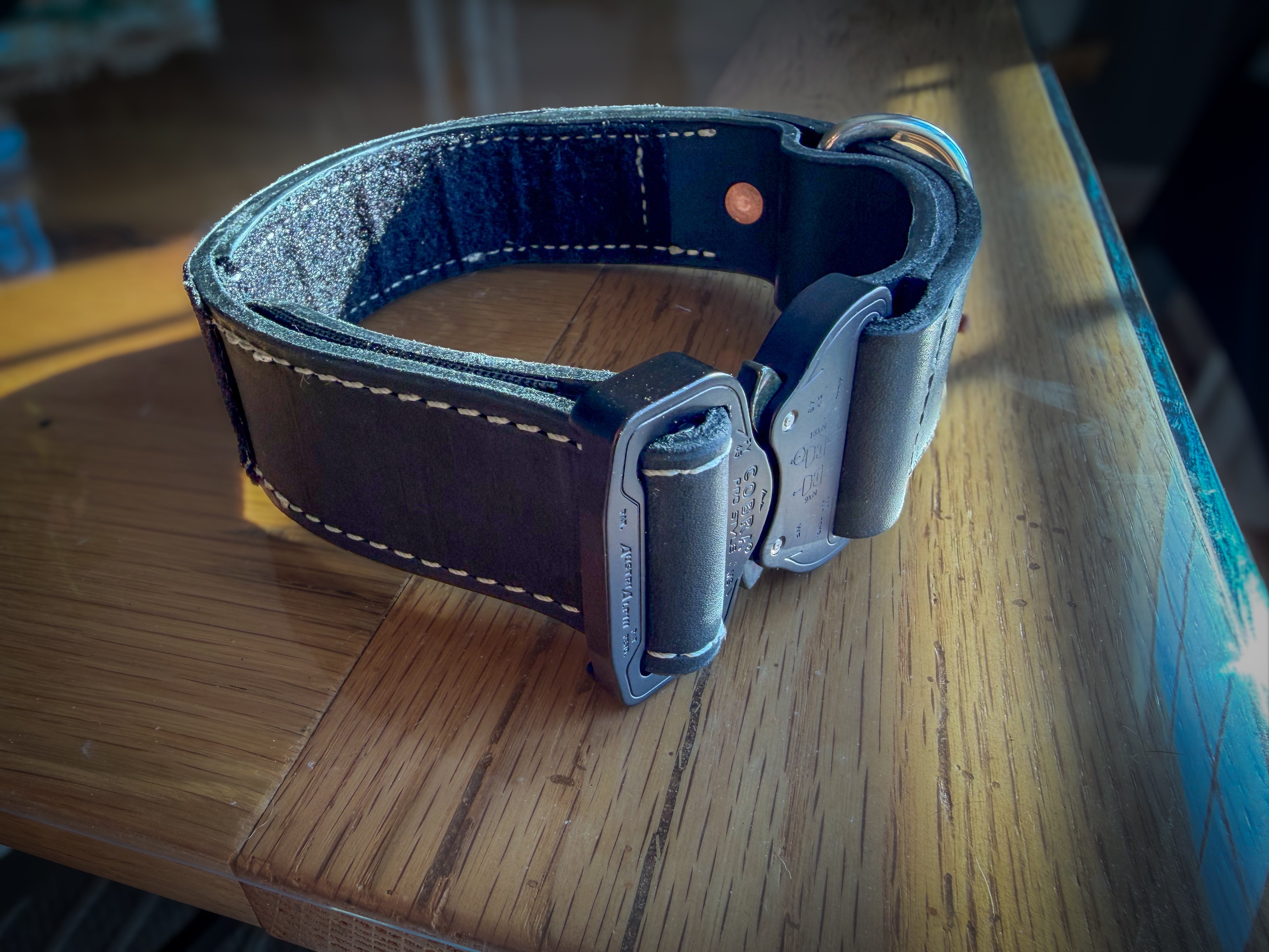 Black leather COBRA collar showing layered leather edge and buckle profile