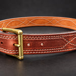 The Young Brand EDC Belt with brass buckle on black studio background