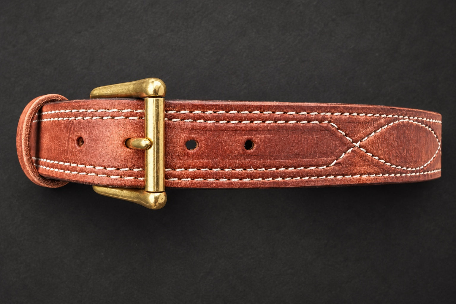The Young Brand EDC Belt front brass buckle and leather stitching on black studio background