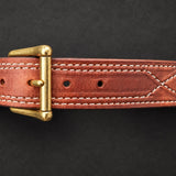 The Young Brand EDC Belt front brass buckle and leather stitching on black studio background
